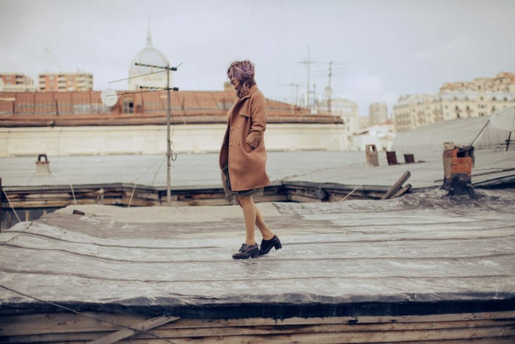 wanita berjalan di atap beton